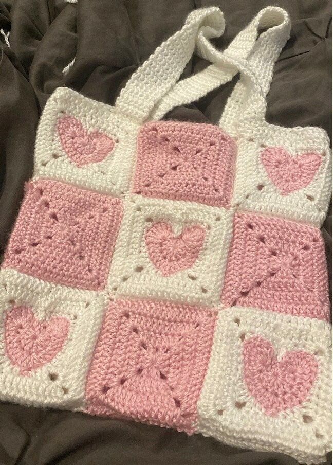 Pink and white granny square tote bag with heart motifs